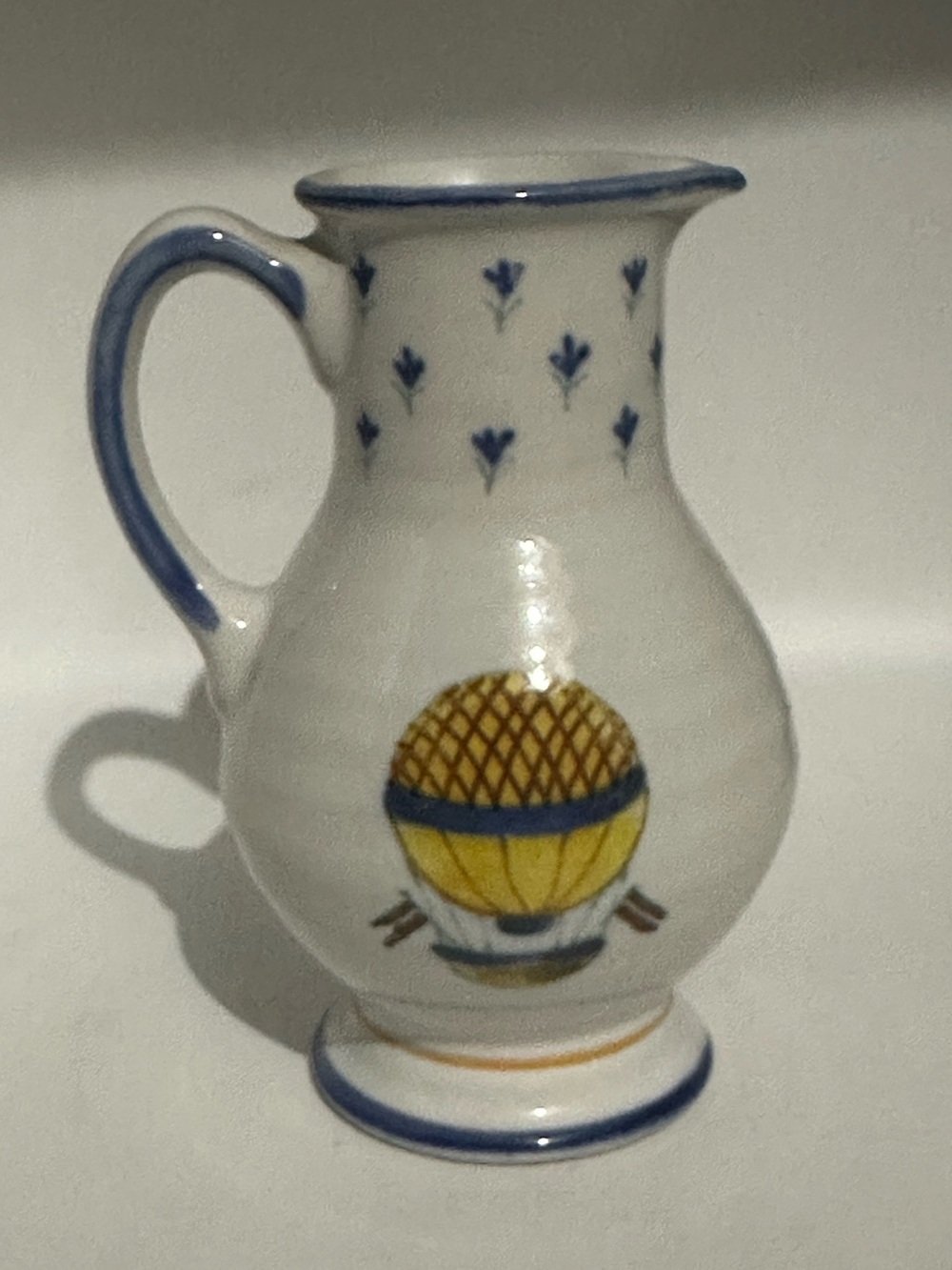 Hand-Painted Ceramic Pitcher with Blue and Yellow Hot Air Balloon Motif